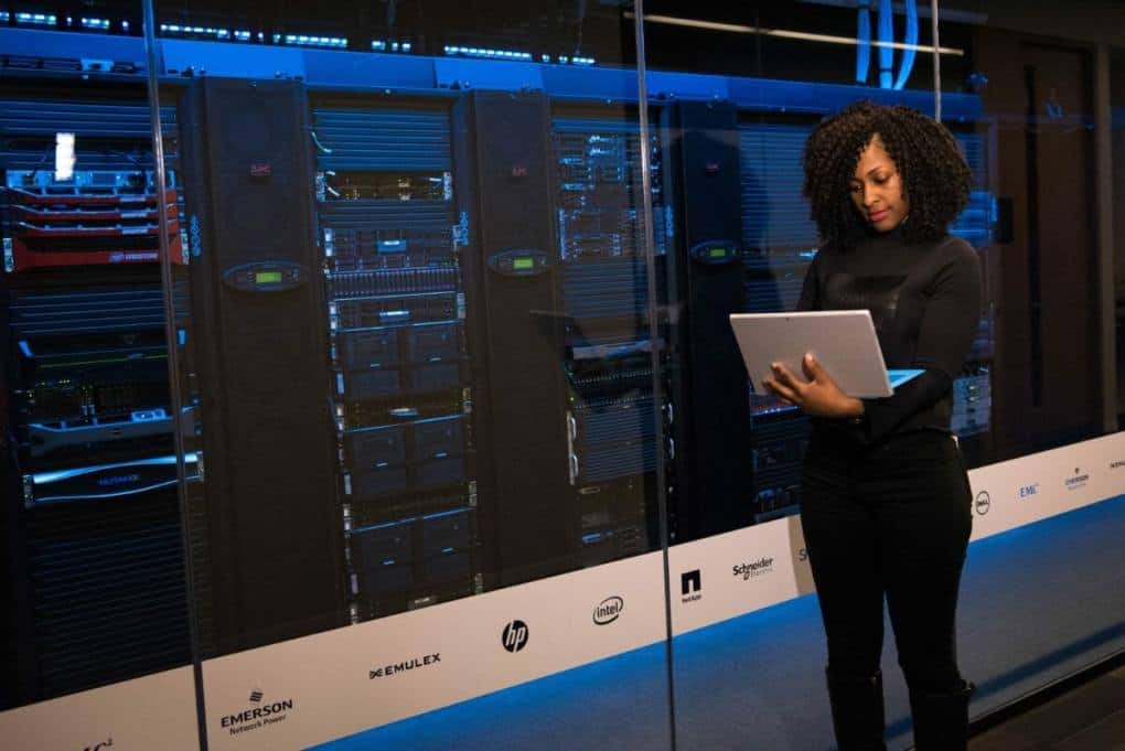 woman holding a laptop in a data room