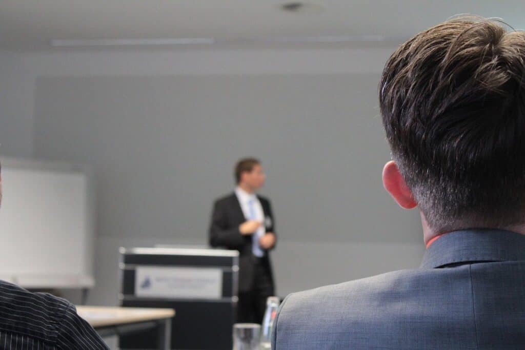 Man listening to lecture Salary After Coding Bootcamp 