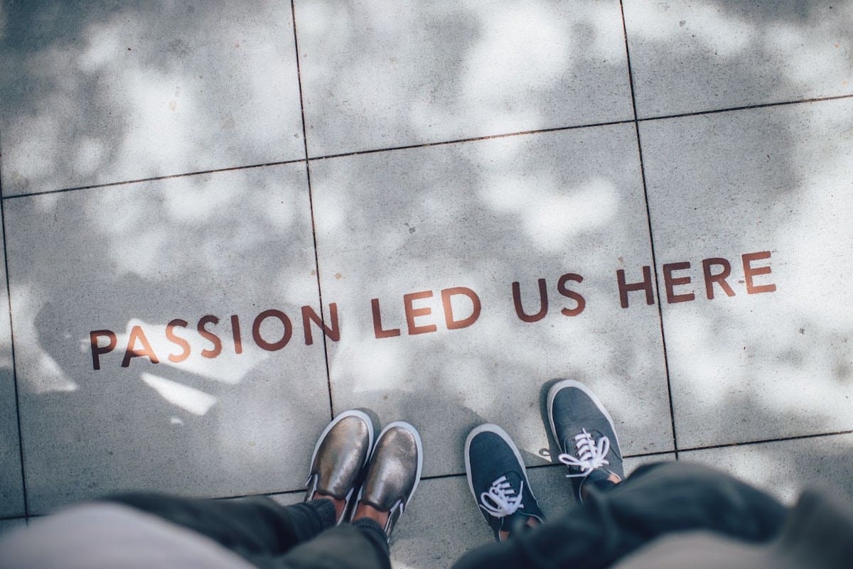 Bird’s eye view of two people standing above words reading "passion led us here"