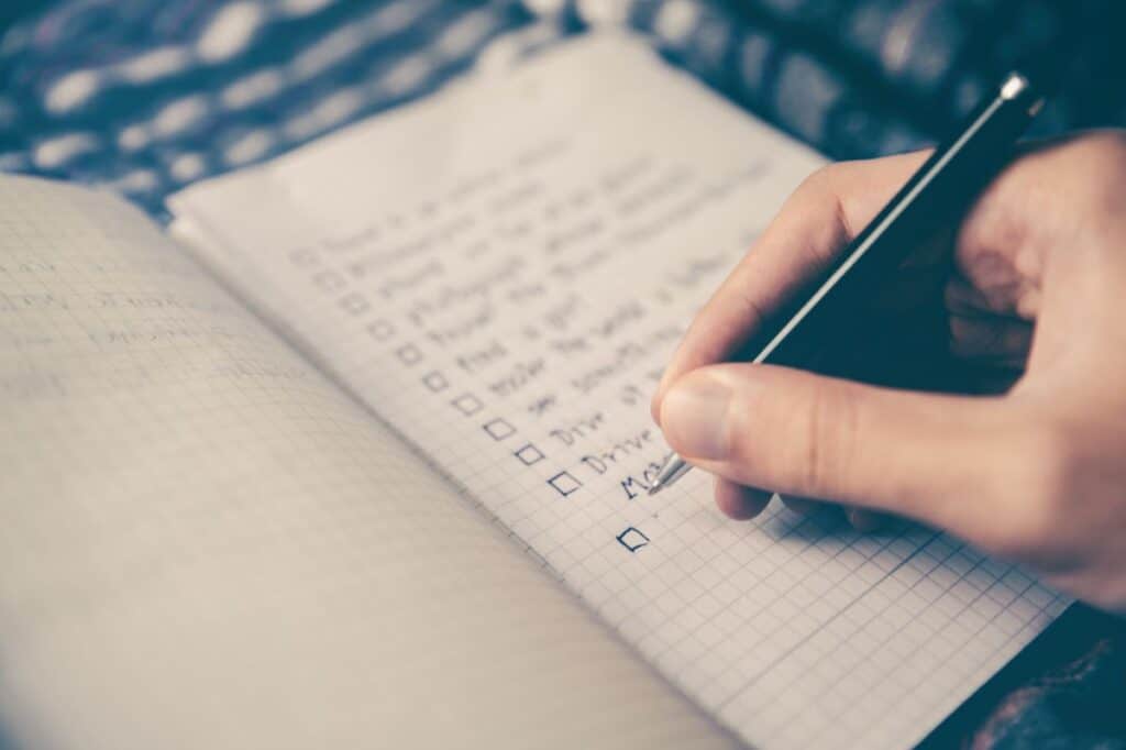 A person writing down his goals  a guide to setting your career goals
