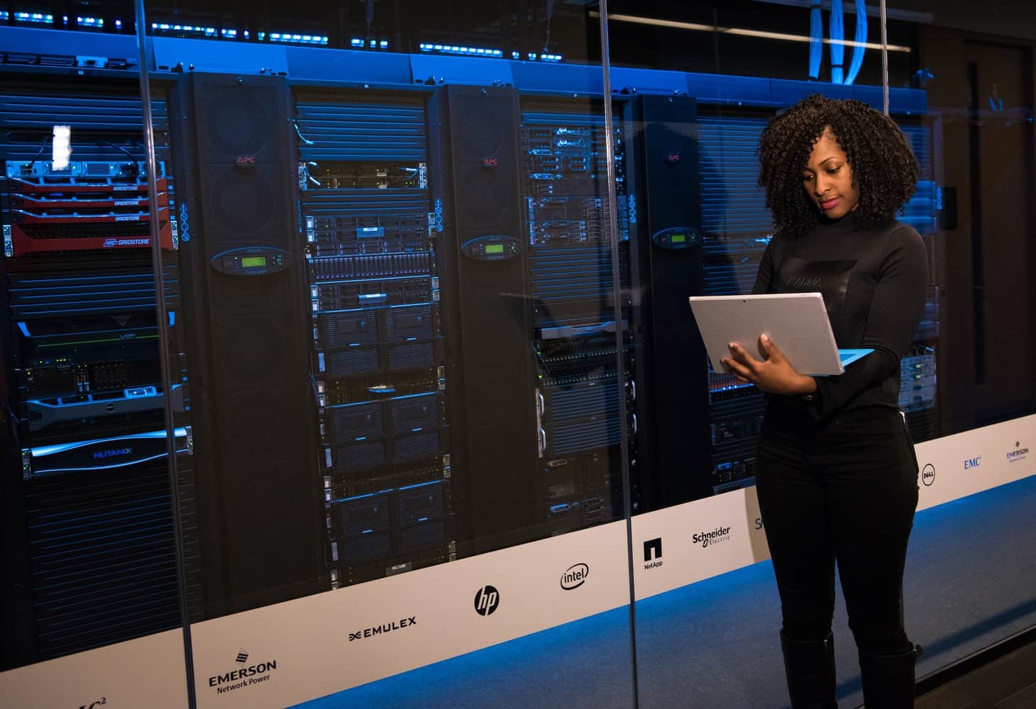 A software engineer standing beside servers. How to Improve Your Chances of Getting Hired at IBM