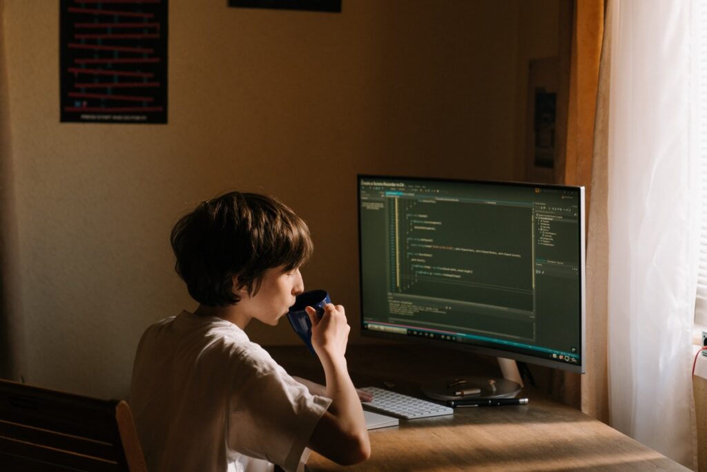Boy learning to code in online coding bootcamp. Coding Bootcamp Cost