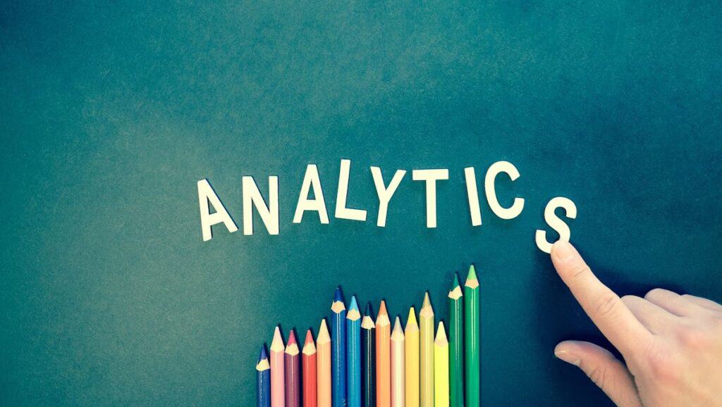  The word ‘Analytics’ is spelled out on a blank canvas with colored pencils at the bottom. Data Analytics vs Data Science